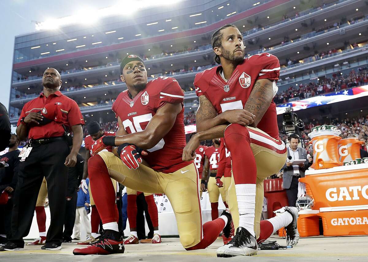 From left, The San Francisco 49's Eli Harold (58), Colin Kaepernick (7) and  Eric Reid (35) kneel during the national anthem before their a game against  the Dallas Cowboys on October 2