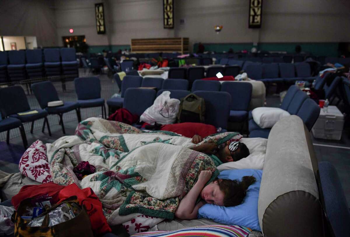 Hurricane Harvey evacuees Stephanie and Nash Ubale sleep for the night at Calvary Community Church in Houston. The couple lost their home to flooding the same week they had a funeral for their newborn twins. "We lost everything and more," they said. The couple are now thinking about moving out of the city. Must credit: Washington Post photo by Ricky Carioti