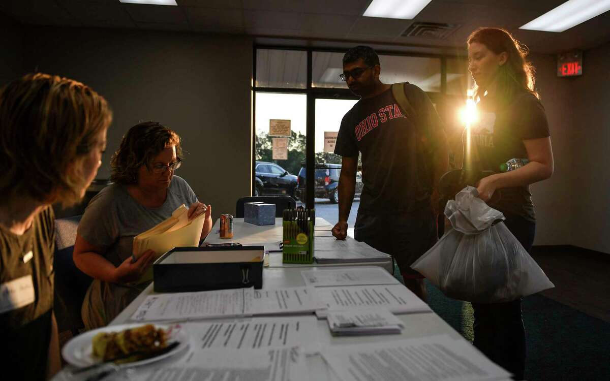 Nash and Stephanie Ubale check in with the help desk at Houston's Calvary Community Church before heading to their flood-damaged home. Calvary had been operating as a shelter ever since Jeff McGee, the church's senior pastor, realized that the official Red Cross facilities in northwest Houston might not have enough room. Must credit: Washington Post photo by Ricky Carioti