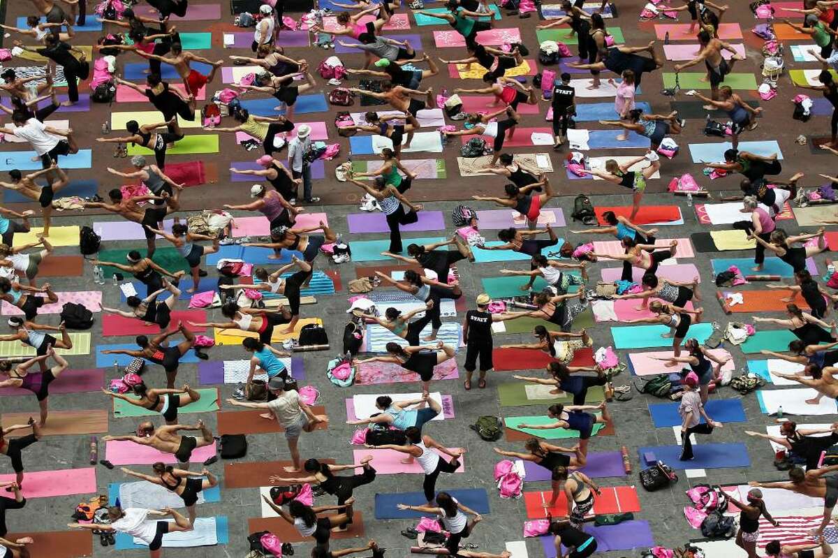 NEW YORK - JUNE 21: Yoga enthusiasts participate in the free annual 'Summer Solstice in Times Square Yoga-thon' June 21, 2010 in New York City. The summer solstice is the first official day of summer and the longest day of the year. (Photo by Mario Tama/Getty Images)