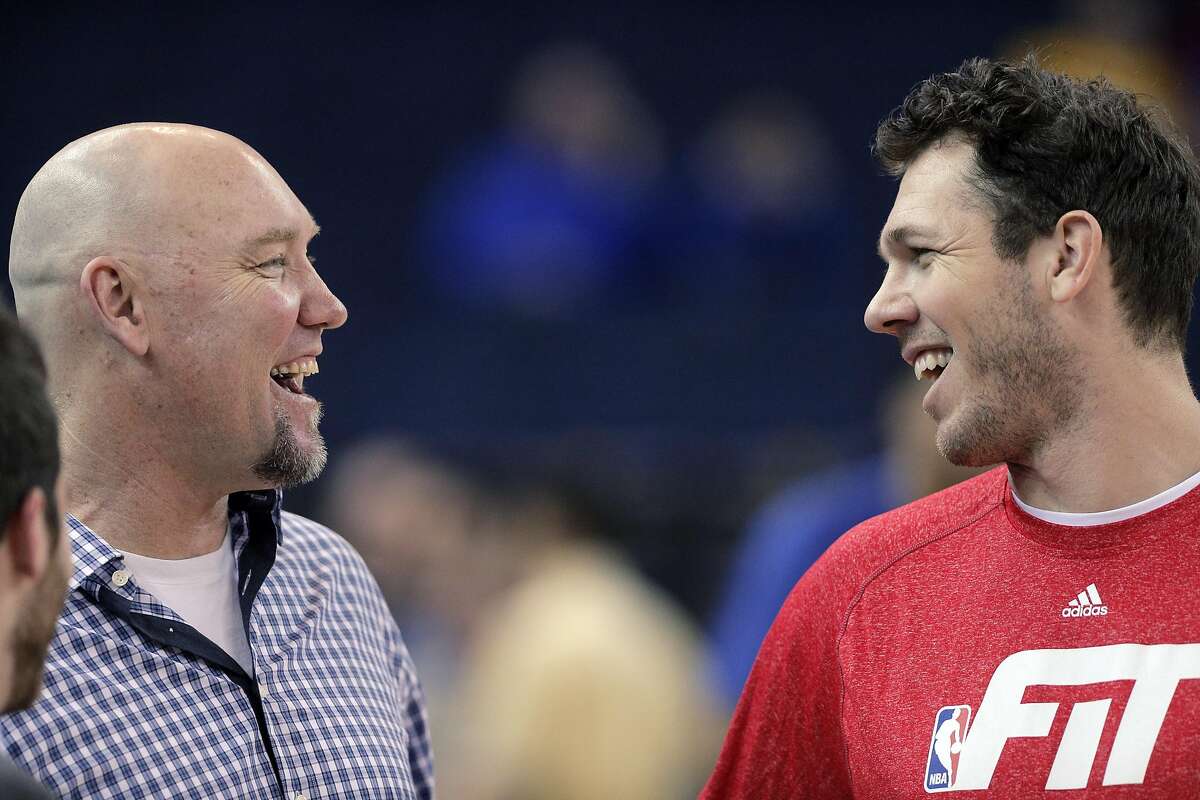 Warriors coach Luke Walton, right, talks with former Warrior and radio personality, Tom Tolbert before the Golden State Warriors played the Boston Celtics at Oracle Arena in Oakland, Calif., on Sunday, January 25, 2015. The Warriors won 114-111.