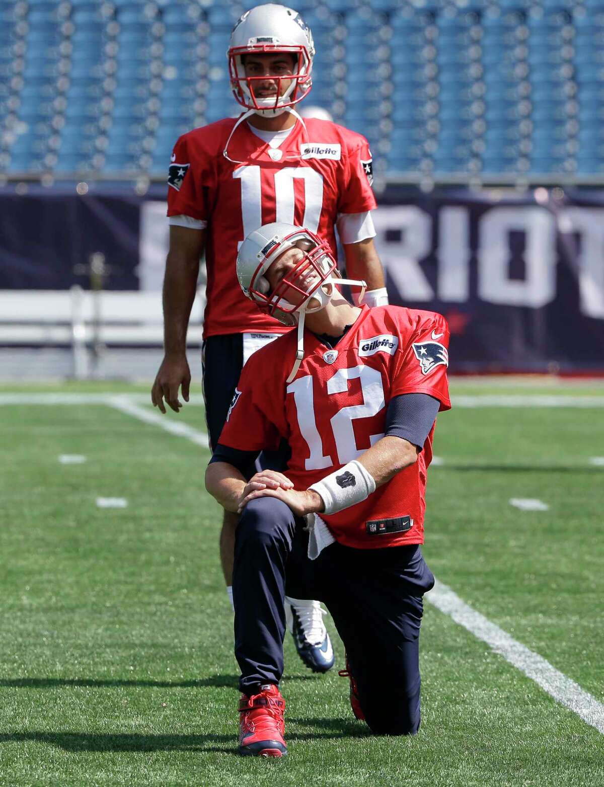 New England Patriots quarterbacks Tom Brady (12) and Jimmy Garoppolo (10) warm up during an NFL football practice, Tuesday, Sept. 5, 2017, in Foxborough, Mass. (AP Photo/Steven Senne) ORG XMIT: MASR101