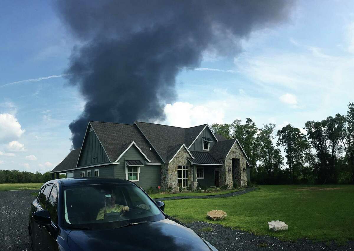 A plume of smoke from Arkema in Crosby can be seen blowing over a nearby home.