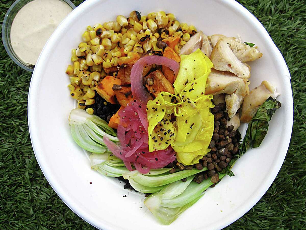 The Good Kind’s menu from the Pearl food hall, including a market bowl with black rice, charred corn, bok choy, lentils, squash, sweet potatoes, pickled onions and chicken, will be part of the cafe’s second location on South St. Mary’s Street at the former home of The Monterey.