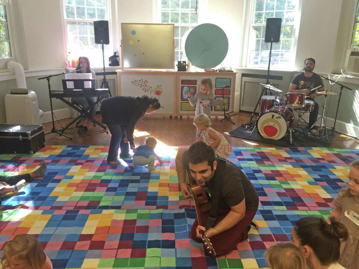 Songs for Seeds band leader and guitarist Matt Terzian encourages children to sing along on Thursday.