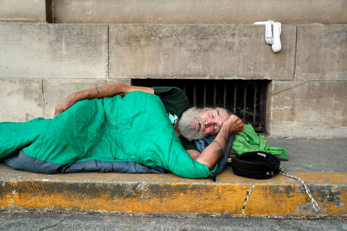 Homeless man, David Delo, 65, snoozes at his sleeping spot behind the Chico Post Office in Chico, Calif. on Wednesday, August 16, 2017.