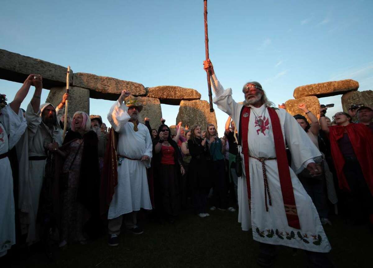 AMESBURY, ENGLAND - JUNE 20: Druid King Arthur Pendragon, conducts a Solstice sunset service as people gather in the megalithic monument of Stonehenge on June 20, 2010 on the edge of Salisbury Plain, west of Amesbury, England. Thousands of revellers began gathering for sunset at the 5,000 year old stone circle to see the sunrise on the following day, which is the longest day of the year in the Northern Hemisphere and is known as the Summer Solstice. (Photo by Matt Cardy/Getty Images) *** Local Caption *** Arthur Pendragon