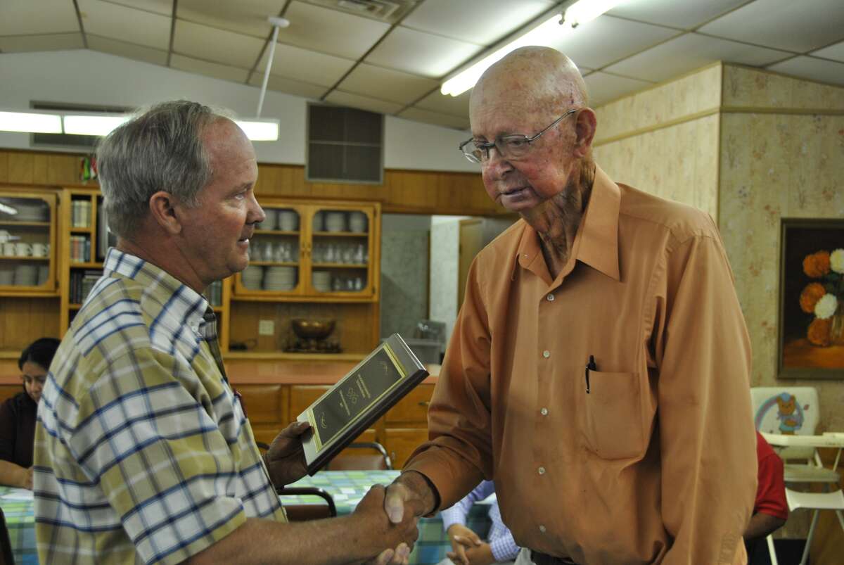 Joe Percy Hart (right) receives a plaque from Hart Cemetery Association Board Member Brad Barnes during the group’s meeting Tuesday, Sept. 5. The plaque recognizes Hart and his late wife, Sarah, for their 17 years of volunteer work for the Hart Cemetery Association. Sarah Hart served as association president until her death on July 25. Joe Hart was a board member.