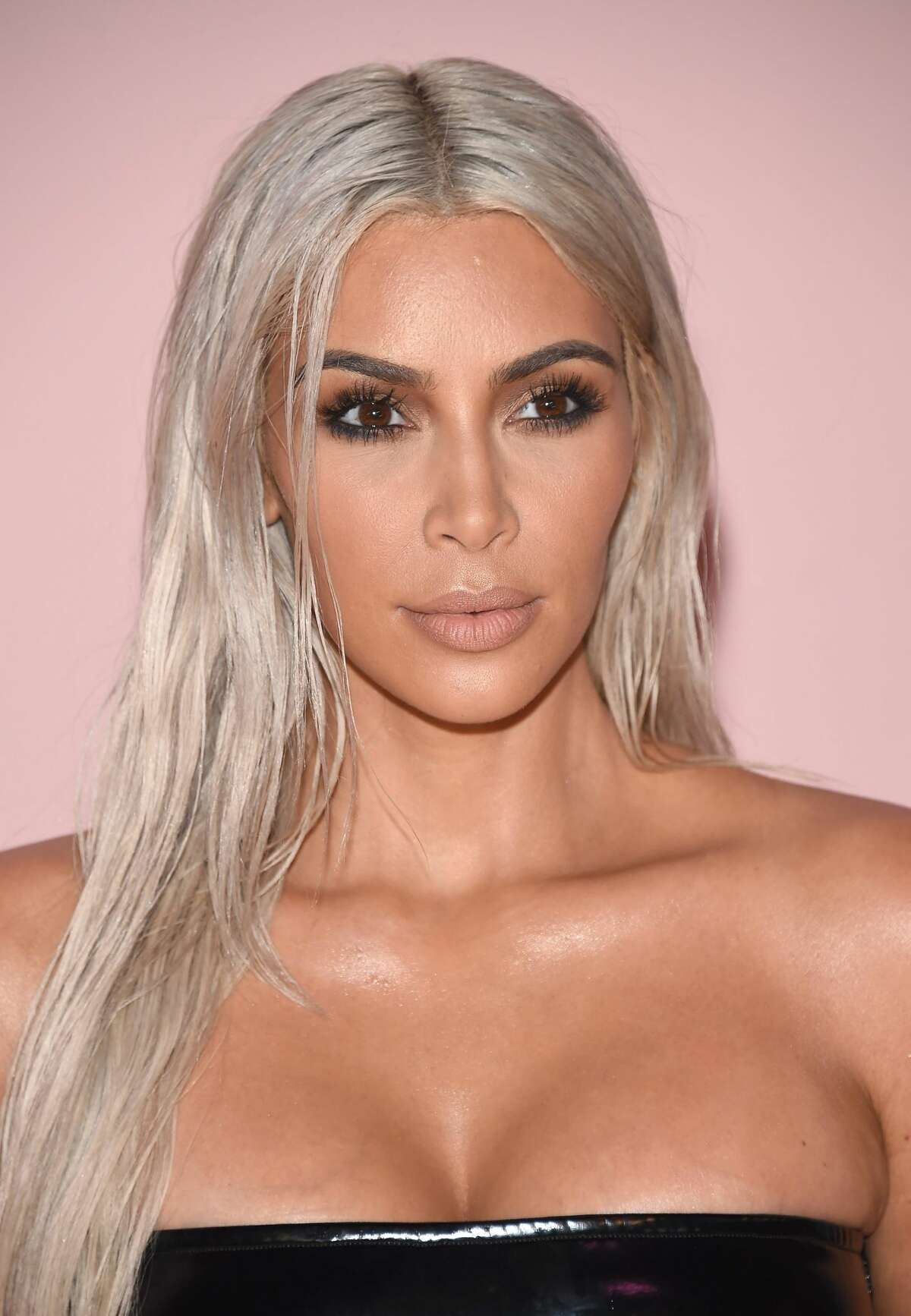 Kim Kardashian attends the Tom Ford fashion with bleach blonde hair. See the whole look...