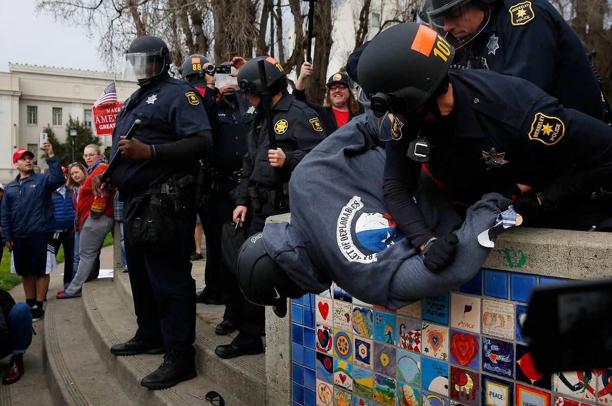 Berkeley police officers arrest a Trump supporter who allegedly had a knife on him during a pro-President Donald Trump rally and march at the Martin Luther King Jr. Civic Center park March 4, 2017 in Berkeley, Calif.