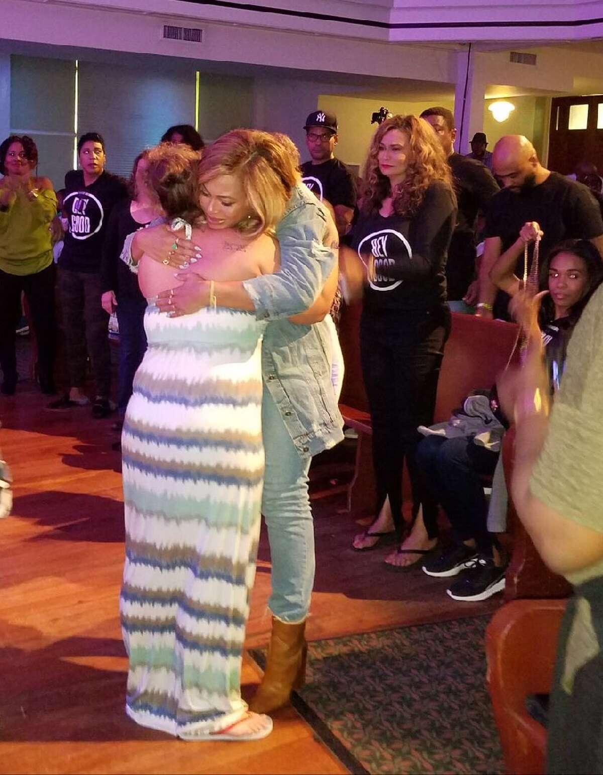 Beyonce hugs an evacuee at St. John's in downtown Houston.