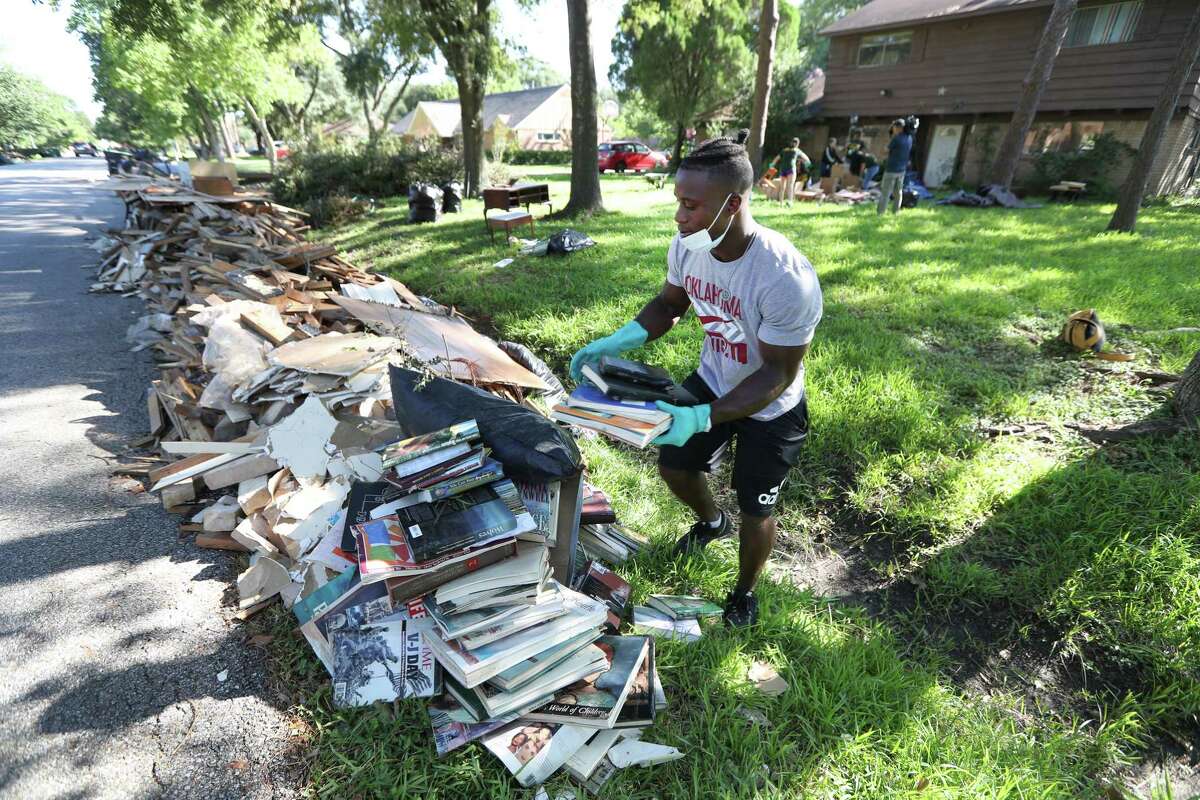 Sharpstown High School student Michael Morris aids in clean-up efforts Thursday, Sept. 7, 2017, in Houston.