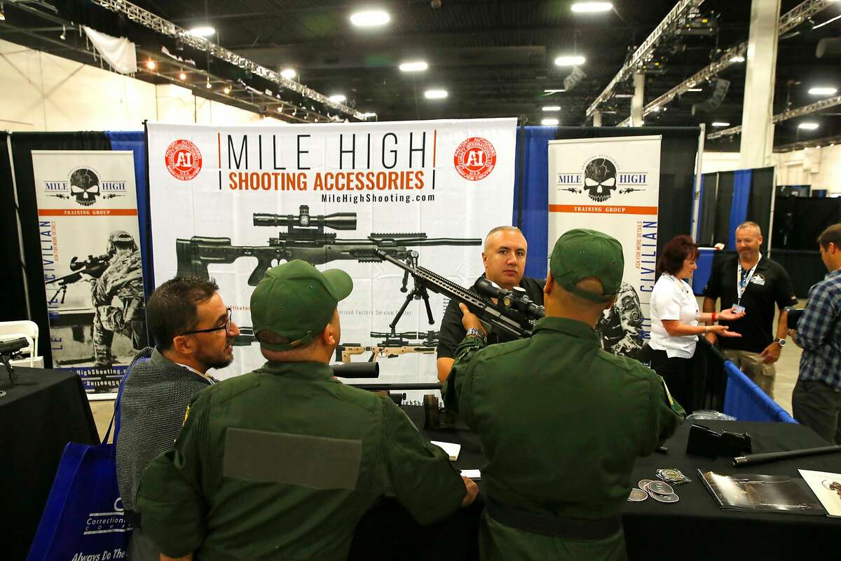 Attendees checks out the many weapons displayed by vendors during the first day of Urban Shield at the Alameda County Fairgrounds in Pleasanton, Ca., on Fri. September 8, 2017.