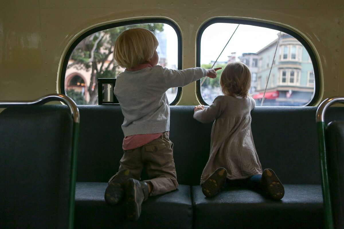 Catherine Andreev, 2, (right) and brother Martin, 3, look out the back window of the retro 41 bus during a ride celebrating Muni Heritage Weekend on Saturday, September 9, 2017 in San Francisco, Calif.