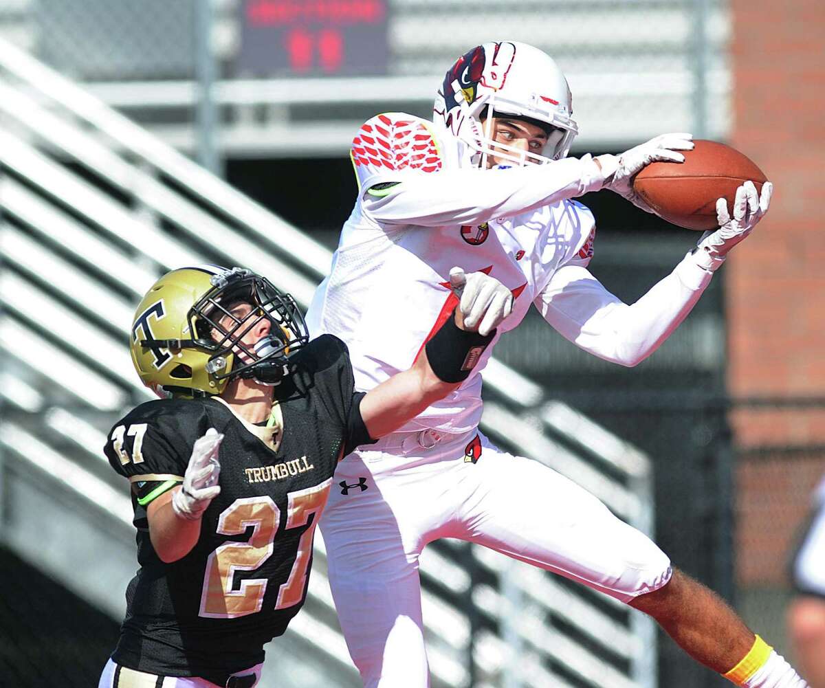 Greenwich receiver Elias Gianopoulos, right, beats Trumbull defender Devin DiCocco to score a touchdown on Saturday.