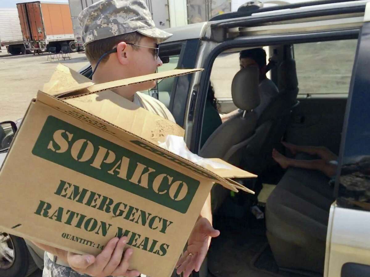 1st Lt. Briscoe Cain, an officer in the Texas State Guard who also is a Republican state representative from Deer Park, loads supplies at a food and water distribution center for people affected by Harvey in Victoria last week.