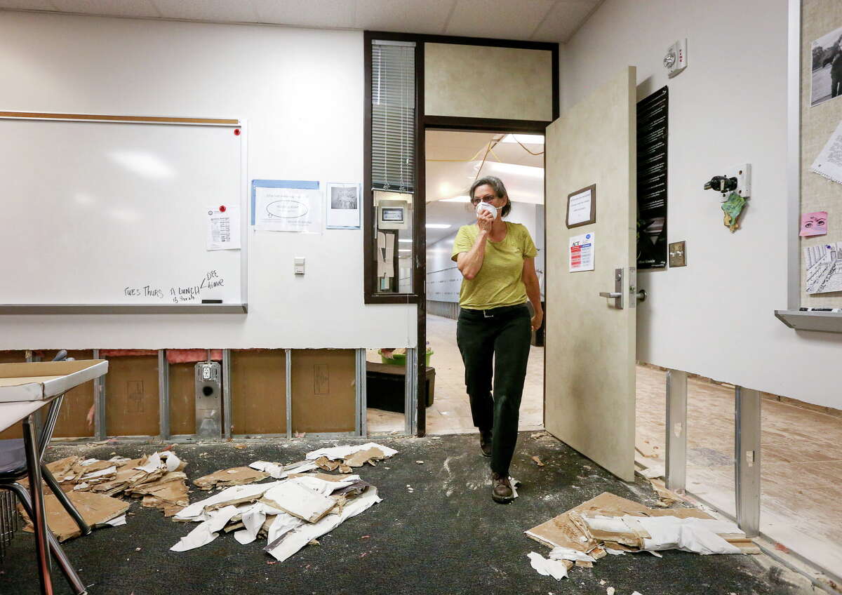 Dee Julian, an AP English teacher from Kingwood High School, removes teaching supplies and a few personal items from her former second-floor classroom at Kingwood High School, Friday, Sept. 8, 2017, in Humble. Teachers were given a 45-minute window to visit their classrooms and remove items, in order to take them to their new campus, Summer Creek High School. "Getting books and highlighters," Julian said. "They're for the kids." ( Jon Shapley / Houston Chronicle )