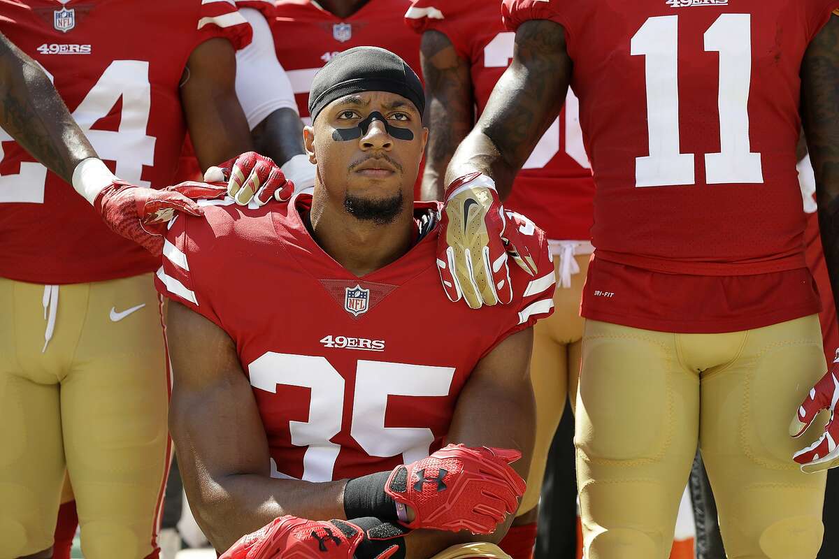 San Francisco 49ers safety Eric Reid (35) kneels in front of teammates during the playing of the national anthem before an NFL football game between the 49ers and the Carolina Panthers in Santa Clara, Calif., Sunday, Sept. 10, 2017. (AP Photo/Marcio Jose Sanchez)