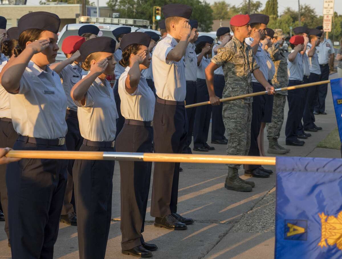 Members of Midland High JROTC stand at attention 9/11/17 as the flag is raised and lowered to half mast outside Midland High School at the 16th annual 9-11 Memorial. Tim Fischer/Reporter-Telegram
