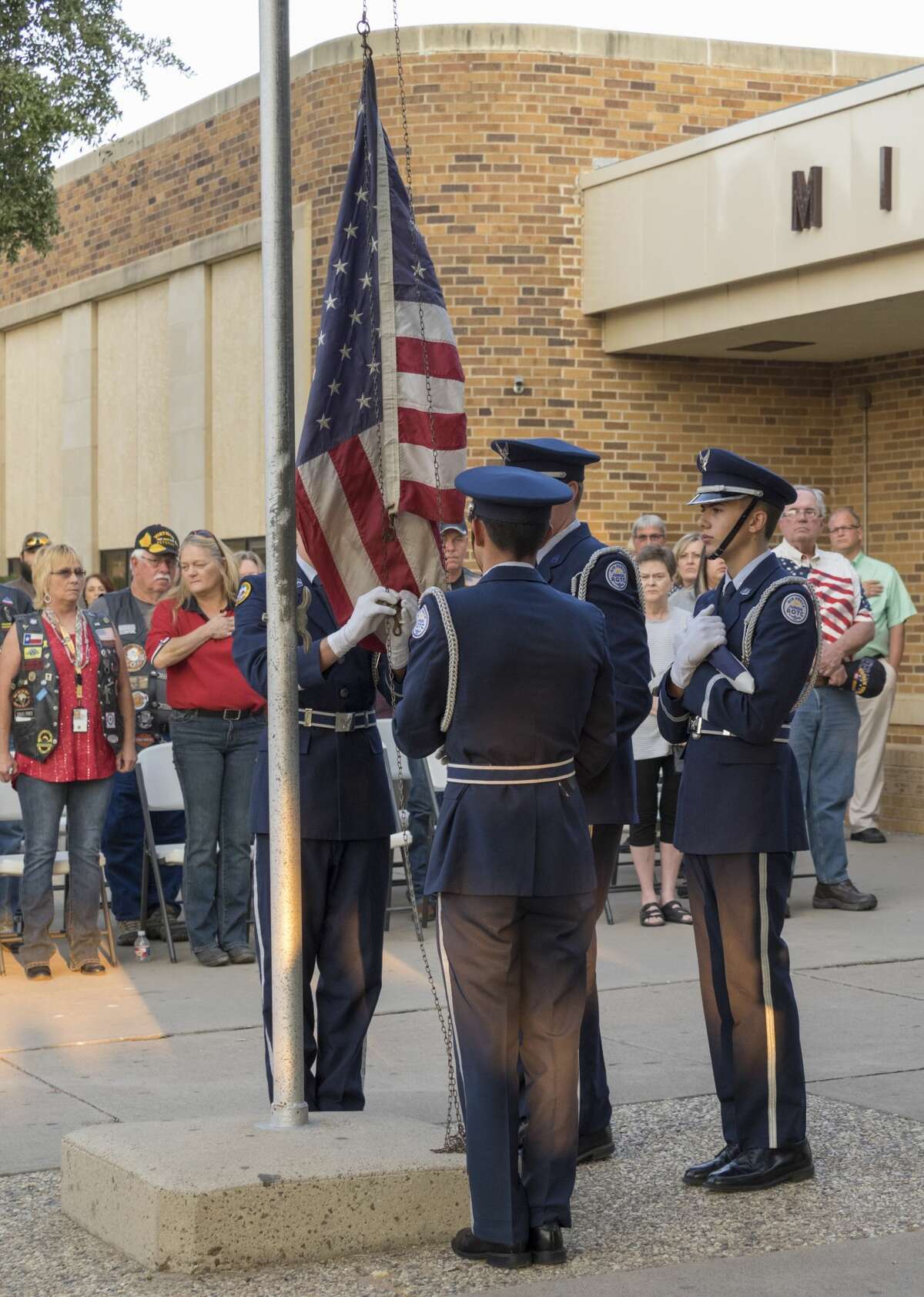 Members of Midland High JROTC raise the flag and then lower it to half mast 9/11/17 outside Midland High School at the 16th annual 9-11 Memorial. Tim Fischer/Reporter-Telegram