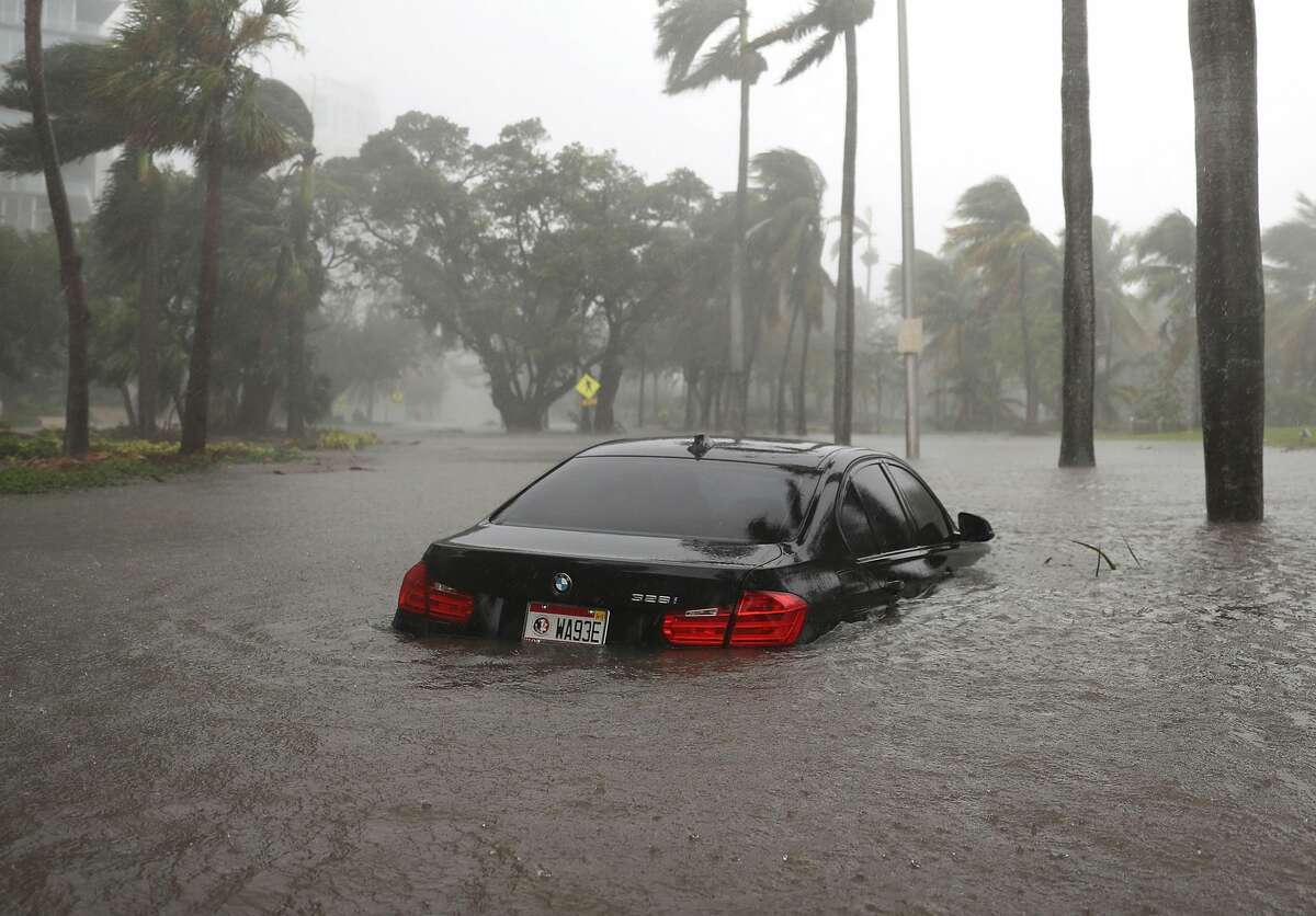 A car is seen in a flooded street as Hurricane Irma passes through on Sept. 10, 2017 in Miami, Florida. Hurricane Irma made landfall in the Florida Keys as a Category 4 storm on Sunday, lashing the state with 130 mph winds as it moves up the coast.