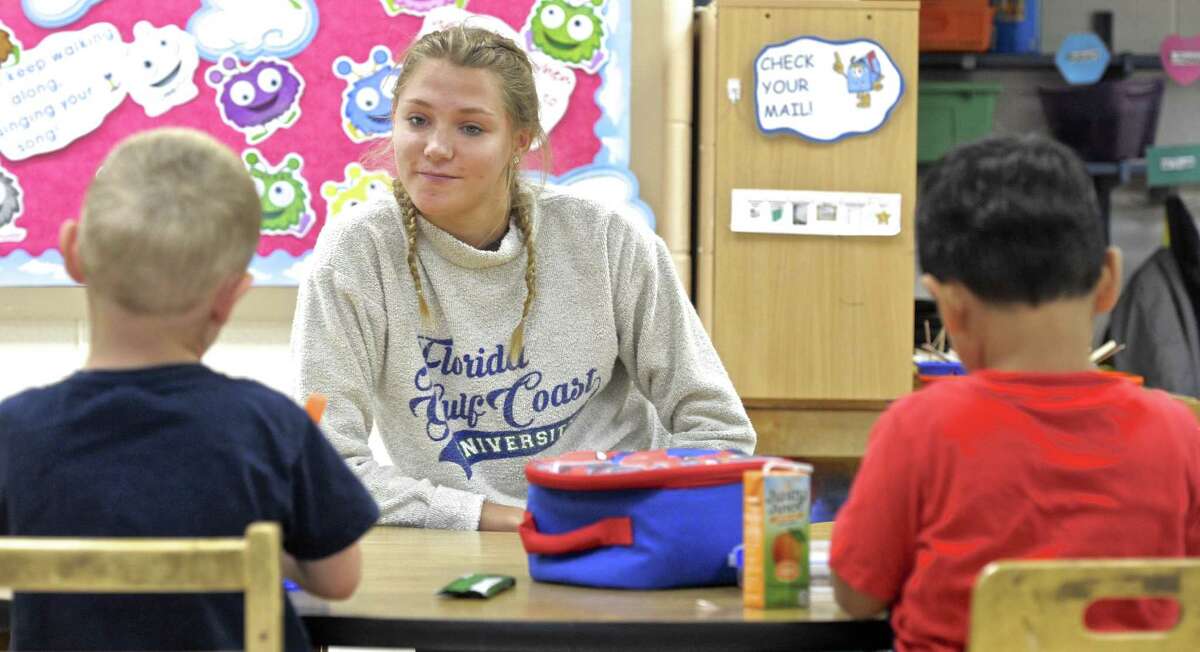 Bethel High School senior Anna Herbert works with students in Lisa Vance's Pre-K 4 class on Thursday morning. Herbert is in the schools "pathways" program, where students pick a concentration in a subject and take courses and internships in that field. Herbert is interning in Bethel's Frank A. Berry School. Thursday, September 7, 2017, in Bethel, Conn.