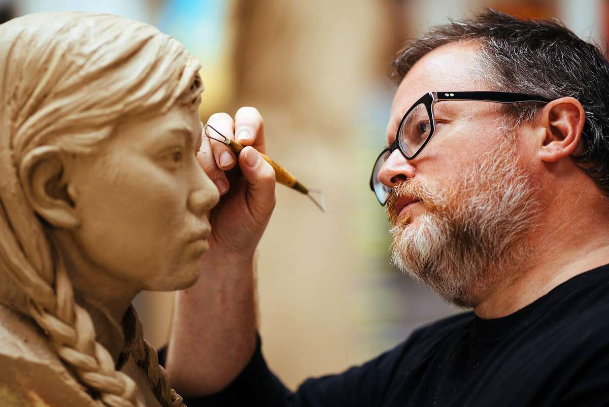 Sculptor Steven Whyte works on the face of one of the girls in the 'Women�s Column of Strength' memorial in his studio in Carmel, Calif. Friday, September 8, 2017.