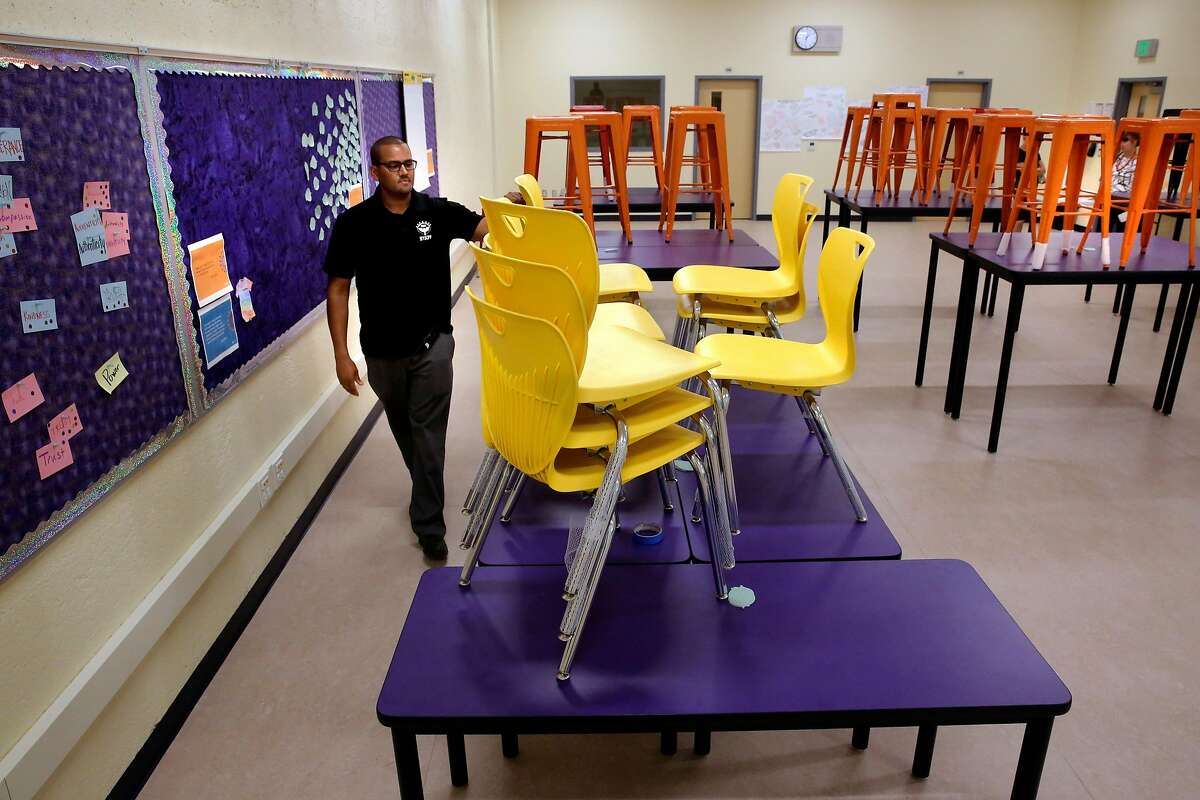 Principal Joe Truss with the new tables and chairs that now fill the collaborative learning space on the Visitation Valley Middle School campus which was made possible using the huge donations of money from Salesforce founder Mark Benioff in Francisco, Ca., as seen on Thurs. September 7, 2017.