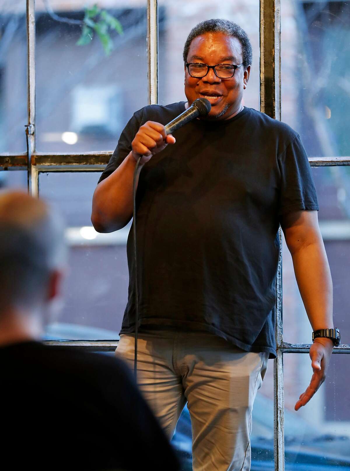 Tony Sparks introduces a comedian during Magic Monday Open Mic at Brainwash Cafe in San Francisco, Calif., on Monday, September 4, 2017.