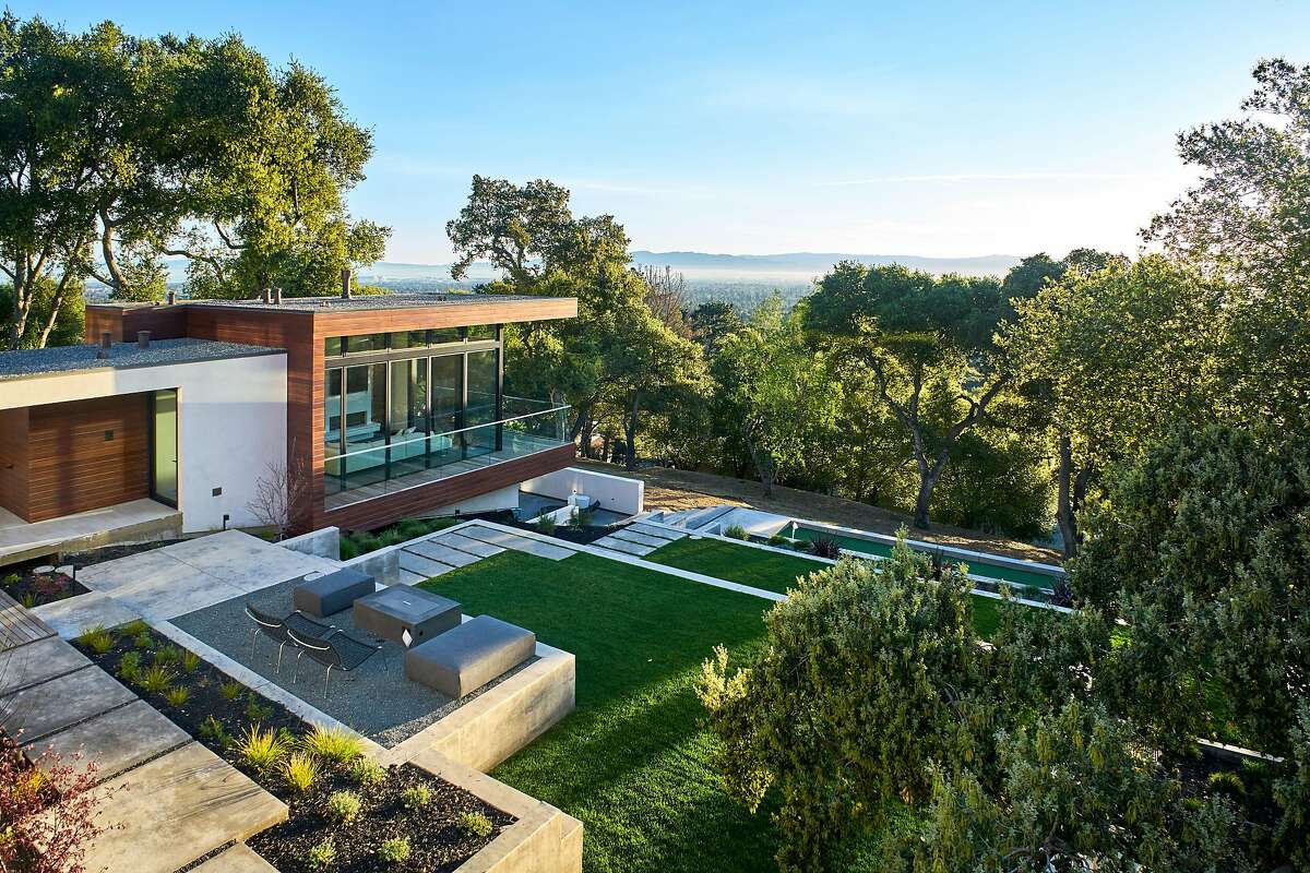 Solar panels top the roof of the Los Altos Hills home.�