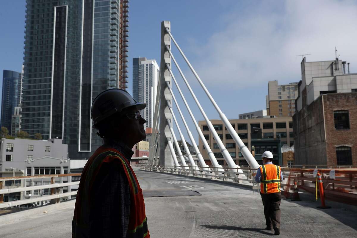 Jack Adams, Construction Manager Oversight, and Dennis Turchon, Senior Construction Manager, left, look out the entry where buses will enter at the site of the new Transbay Terminal which is still under construction in San Francisco, on Wednesday, August 23, 2017.at the site of the new Transbay Terminal which is still under construction in San Francisco, on Wednesday, August 23, 2017.