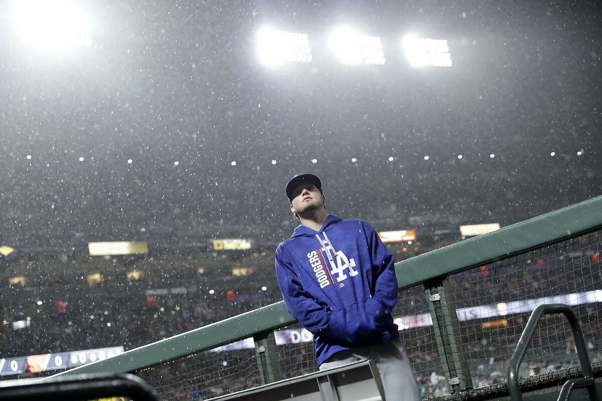 Los Angeles Dodgers' Alex Verdugo looks up at the rain during a delay during a baseball game against the San Francisco Giants, Monday, Sept. 11, 2017, in San Francisco. 