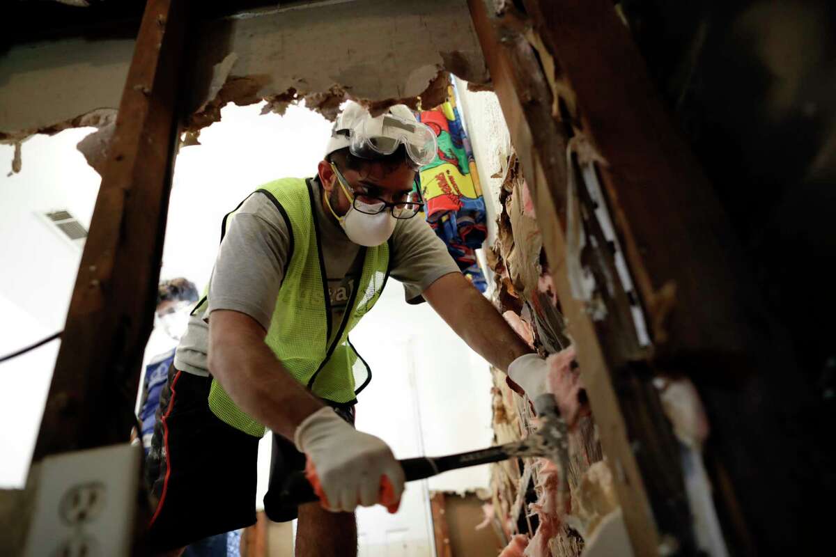 Volunteer Hashir Ayubi of the the Ahmadiyya Muslim Youth Association helps clean out a flood-damaged home in Houston.