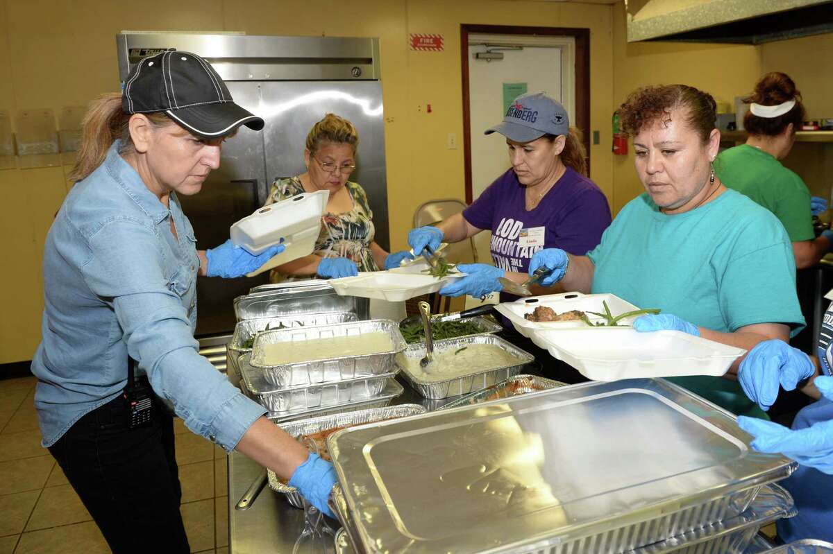 Volunteers prepare hot meals that will be distributed to flood victims at Our Lady of Guadalupe Church in Rosenberg, TX on September 7, 2017.
