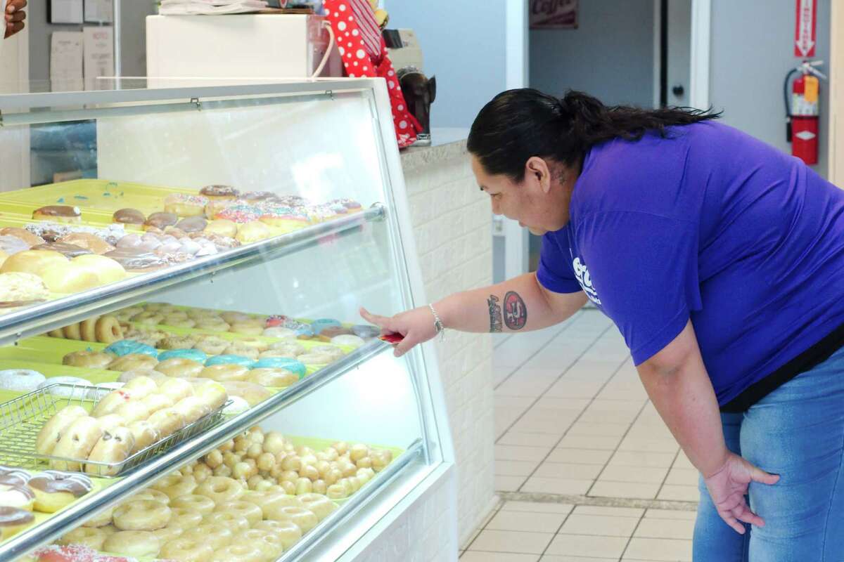 Jennifer Reyna selects a donut at Donald's DonutS.