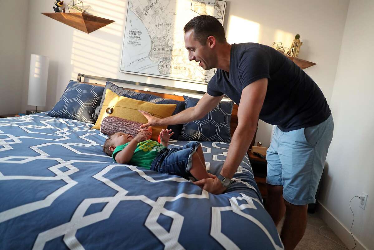 Nick Williams and his son, Rio, 15 months, at their new residence in Station House development in West Oakland neighborhood of Oakland, Calif., on Wednesday, September 6, 2017.