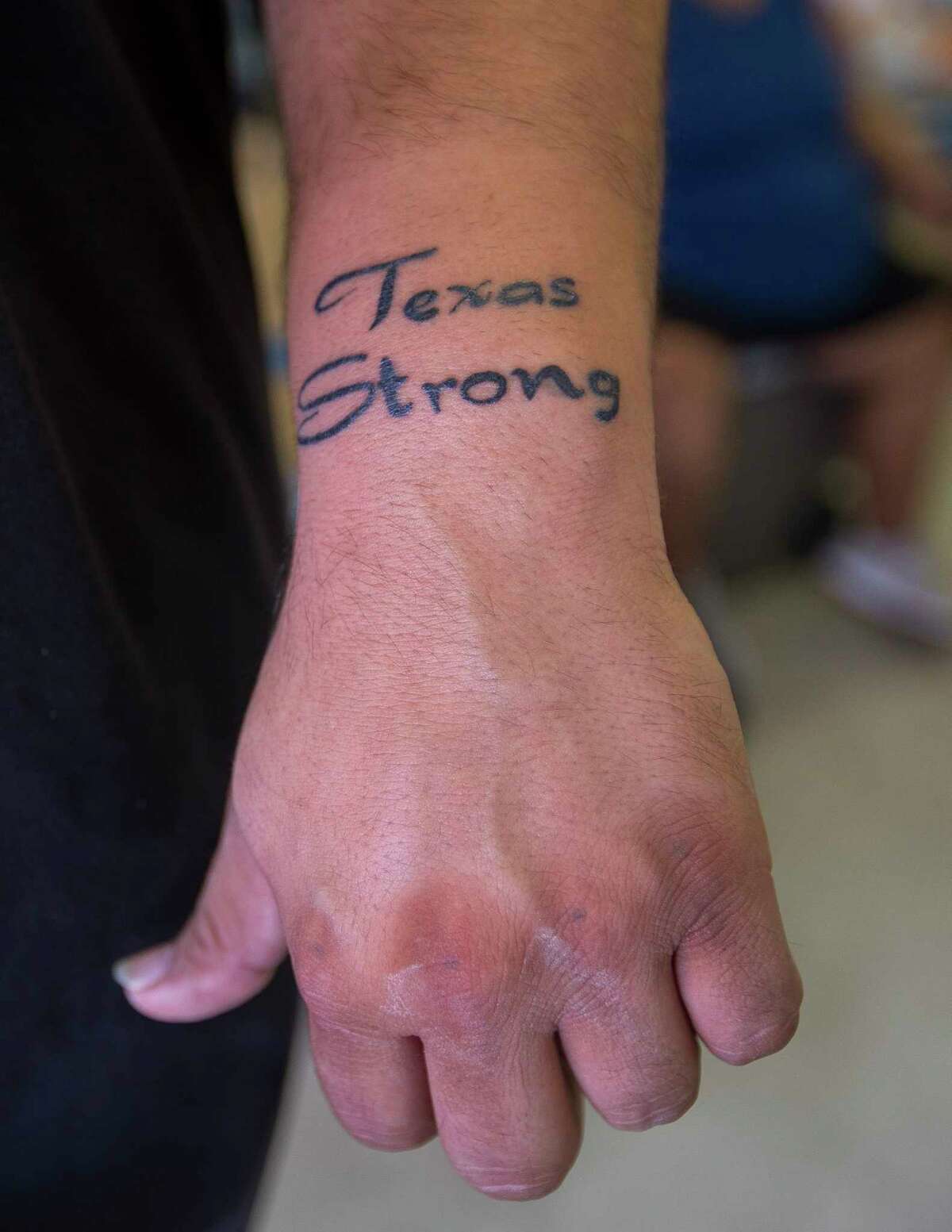 "Surviving" is how Brian Torres, of Tivoli, TX, describes the reason for his new 'Texas Strong' tattoo, Tuesday, Sept. 12, 2017. Torres rode the storm out in a trailer in Tivoli, an unincorporated town located between Port Lavaca and Rockport, a harrowing experience he likens to that feeling when a plane is just about to touch down on the runway and bounces continuously.