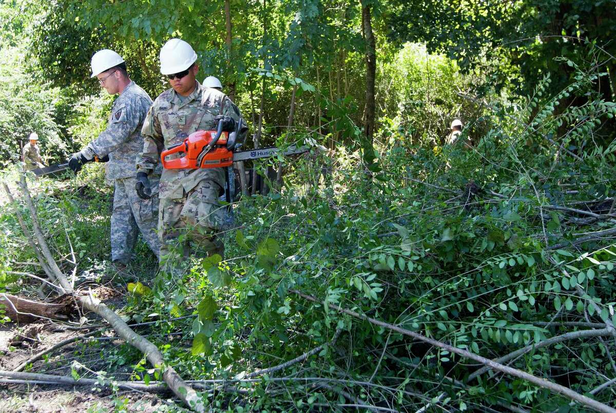80 members of the National Guard work to clear out an area of land off FM 149 and Martin Luther King Jr. Drive which floods frequently, Friday, Sept. 8, 2017, in Montgomery. The work after Tropical Storm Harvey will serve to jump start the larger project as part of a General Land Office grant scheduled to be completed this winter.