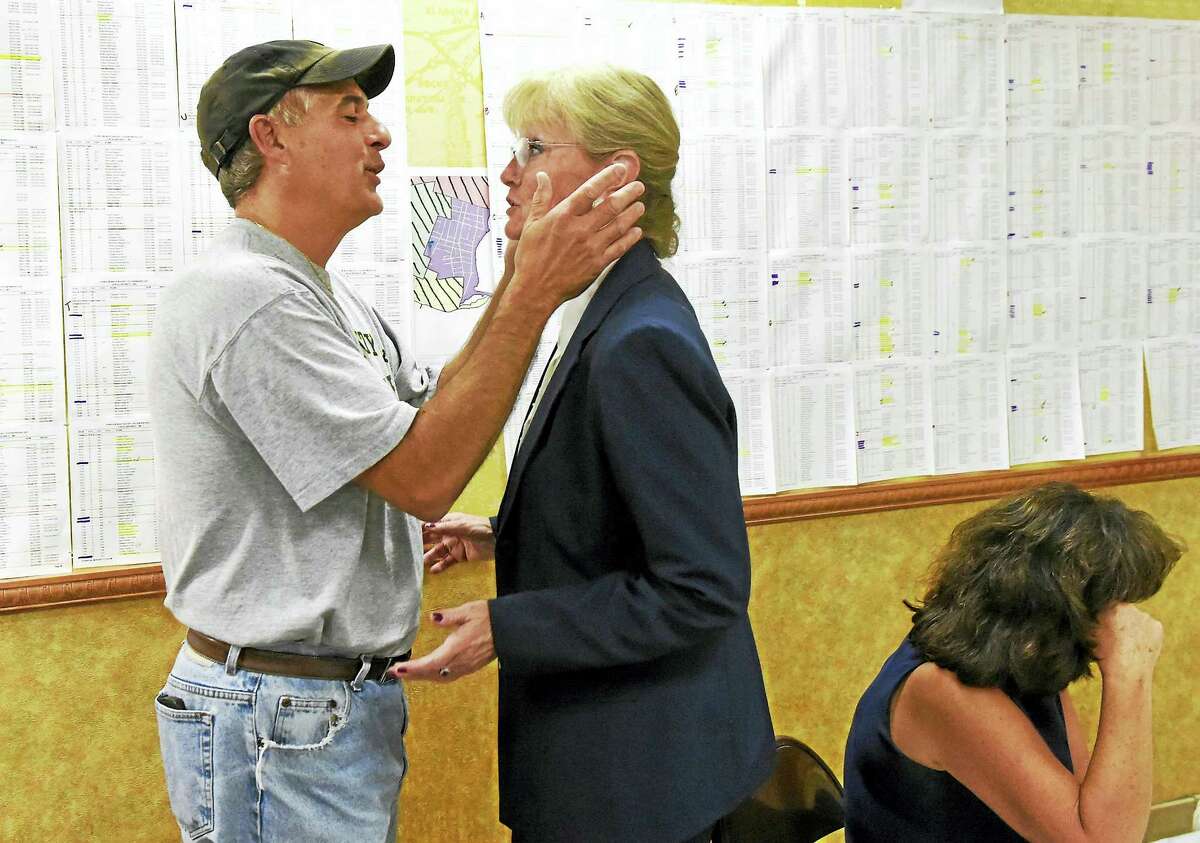 Nancy Rossi is congratulated by former West Haven Mayor John M. Picard at Rossi’s campaign headquarters Tuesday night.