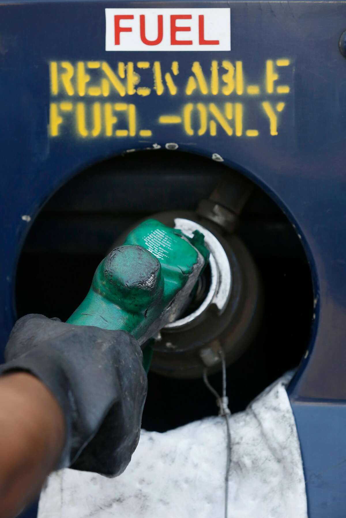 Oscar Muro, Golden Gate Petroleum trainer, fills a Capital Corridor locomotive with rewnewable diesel at the Amtrak Maintenance Facility on Tuesday, September 12, 2017 in Oakland, Calif.