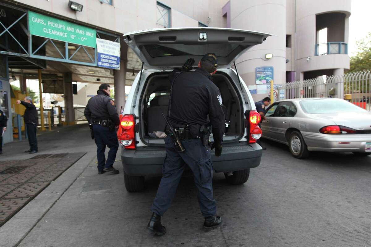 U.S. Customs and Border Patrol agents search a vehicle at the Nogales Border Station in Nogales, Ariz. A lawsuit filed by the American Civil Liberties Union and the Electronic Frontier Foundation on Wednesday argues that searches of phones and laptops at the border are in violation of the First and Fourth Amendments.