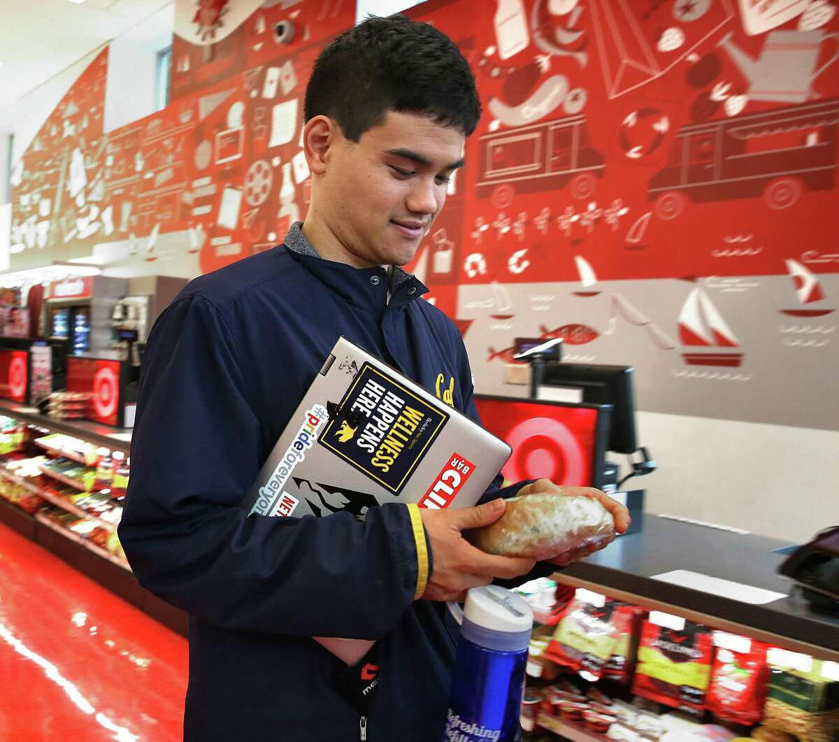 A student grabs a snack at Target on Shattuck Ave. near the UC Berkeley campus on Friday in Berkeley, Calif. Target looks to hire 100,000 for the holiday season, a 40 percent jump over last year.