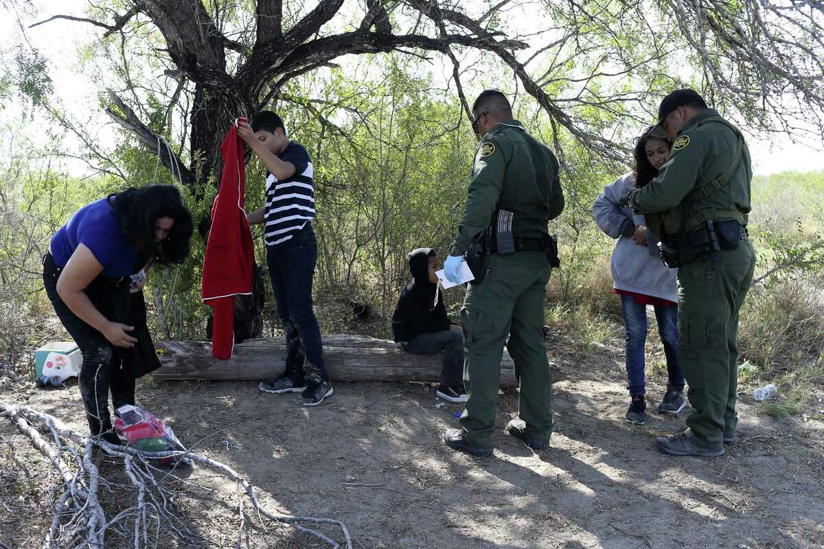 U.S. Border Patrol agents detain Central American families crossing into the U.S. in western Starr County, Tuesday, Sept. 12, 2017.
