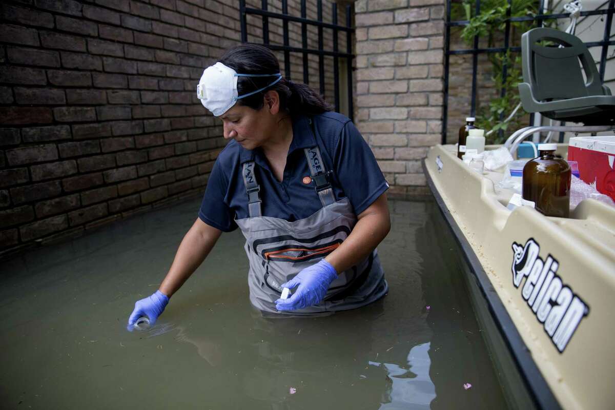 A worker collects water samples in neighborhoods affected by flooding from Hurricane Harvey in Houston, Sept. 5, 2017. Hurricane Harvey cut a path through industrial corridors, raising concerns about pollution and runoff, and Griffin?•s property lies a few hundred yards from a Superfund site that was inundated in the storm. (Eric Thayer/The New York Times)
