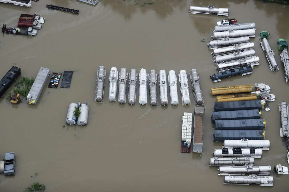 Industrial vehicles sit in floodwaters from Tropical Storm Harvey on Tuesday, Aug. 29, 2017, in Houston. ( Brett Coomer / Houston Chronicle )