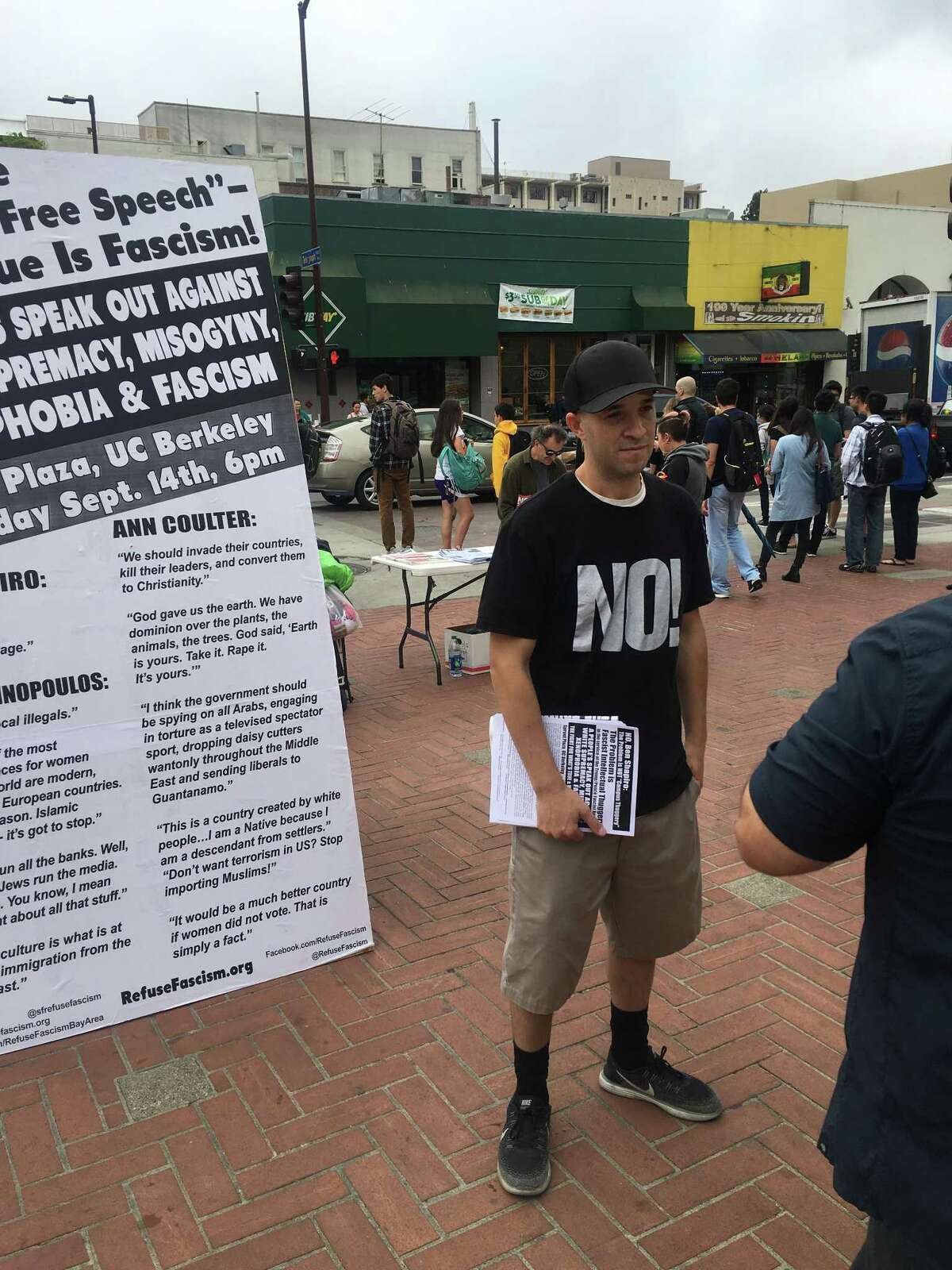 An unidentified critic of Ben Shapiro passes out posters s a day before the conservative commentator is scheduled to speak on campus on Wednesday September 13, 2017 in Berkeley.