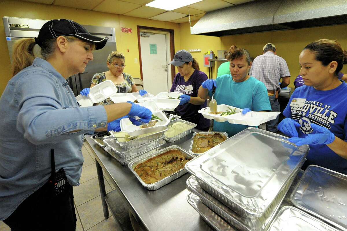 Volunteers prepare hot meals to be distributed to flood victims at Our Lady of Guadalupe Church in Rosenberg, TX on September 7, 2017.