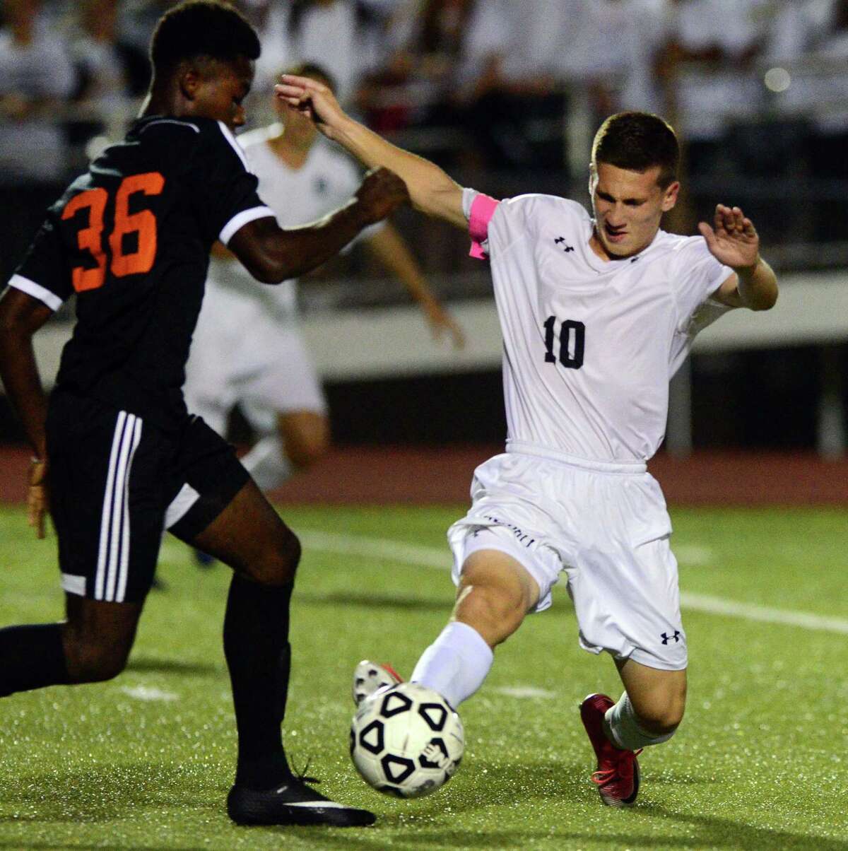 Trumbull’s Nicholas Moussavian reaches the ball as Stamford’s Emmanuel Moran tries to intercept on Wednesday in Trumbull.