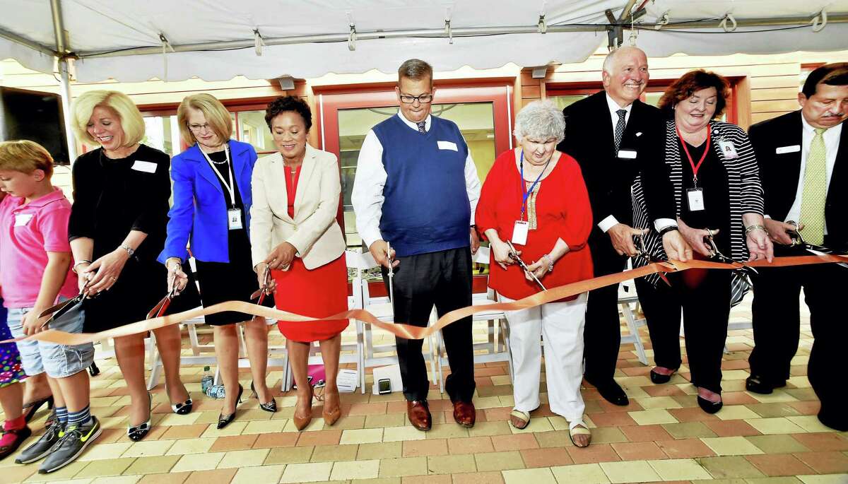 Cutting the ribbon Wednesday for the new Ronald McDonald House are, from left, Bennet Arnold, 7, of Ledyard; Cynthia Sparer, executive director of the Yale New Haven Children’s Hospital; Marna Borgstrom, president/CEO Yale New Haven Health System; Scott Taylor, president of the Connecticut and Western Massachusetts McDonald’s Owner Operators Association; Claire DiMartino of East Haven, founder of the Ronald McDonald House of CT; Stocky Clark, executive director of the Ronald McDonald House of CT; Ellen Good, president of RMH of CT Advisory Board; and Michael Favreau, president of RMHC-CTMA board of directors.