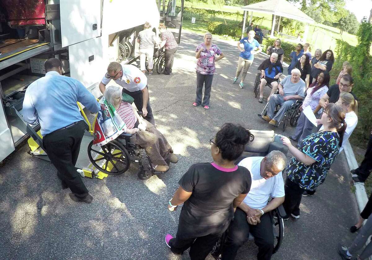 Elderly evacuees at Westwood Nursing and Rehabilitation Center in Fort Walton Beach, Fla., are loaded onto a bus after eight people died at another facility. on Wednesday.﻿